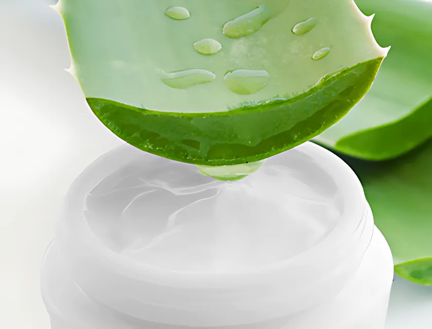 Aloe vera gel dripping into cosmetic jar