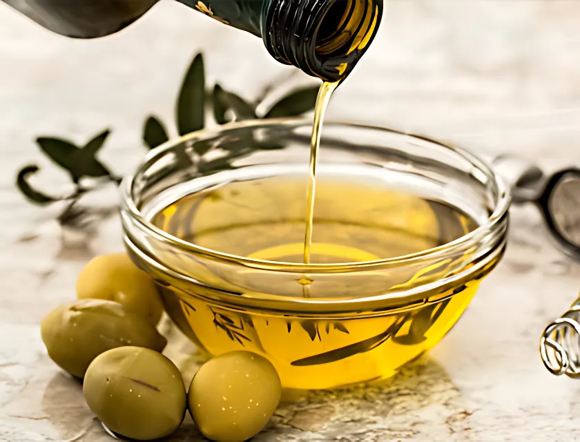 Olive oil pouring into bowl